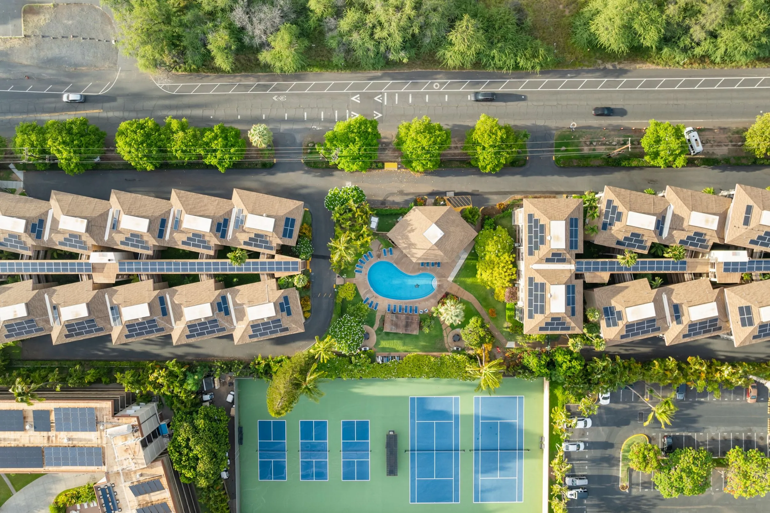 Aerial view of the property showing the pool and sport courts