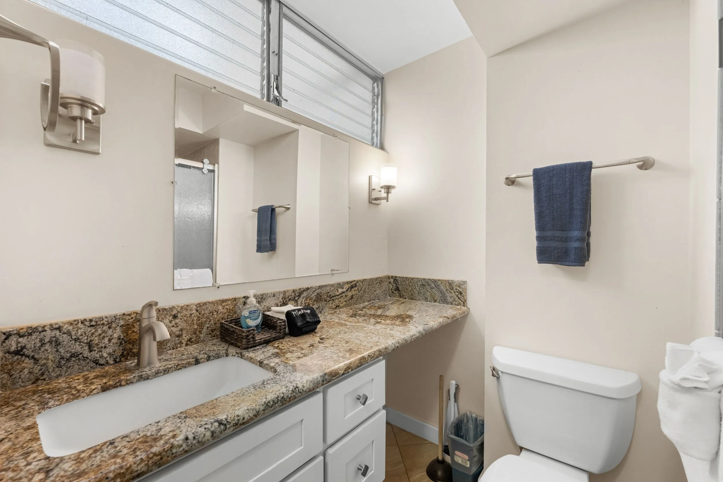 Bathroom with a granite vanity and a standing shower