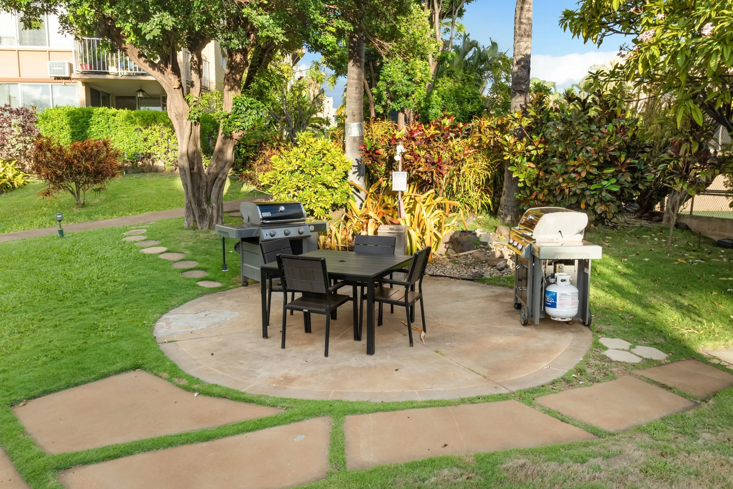 BBQ grills and outdoor dining tables on the lawn