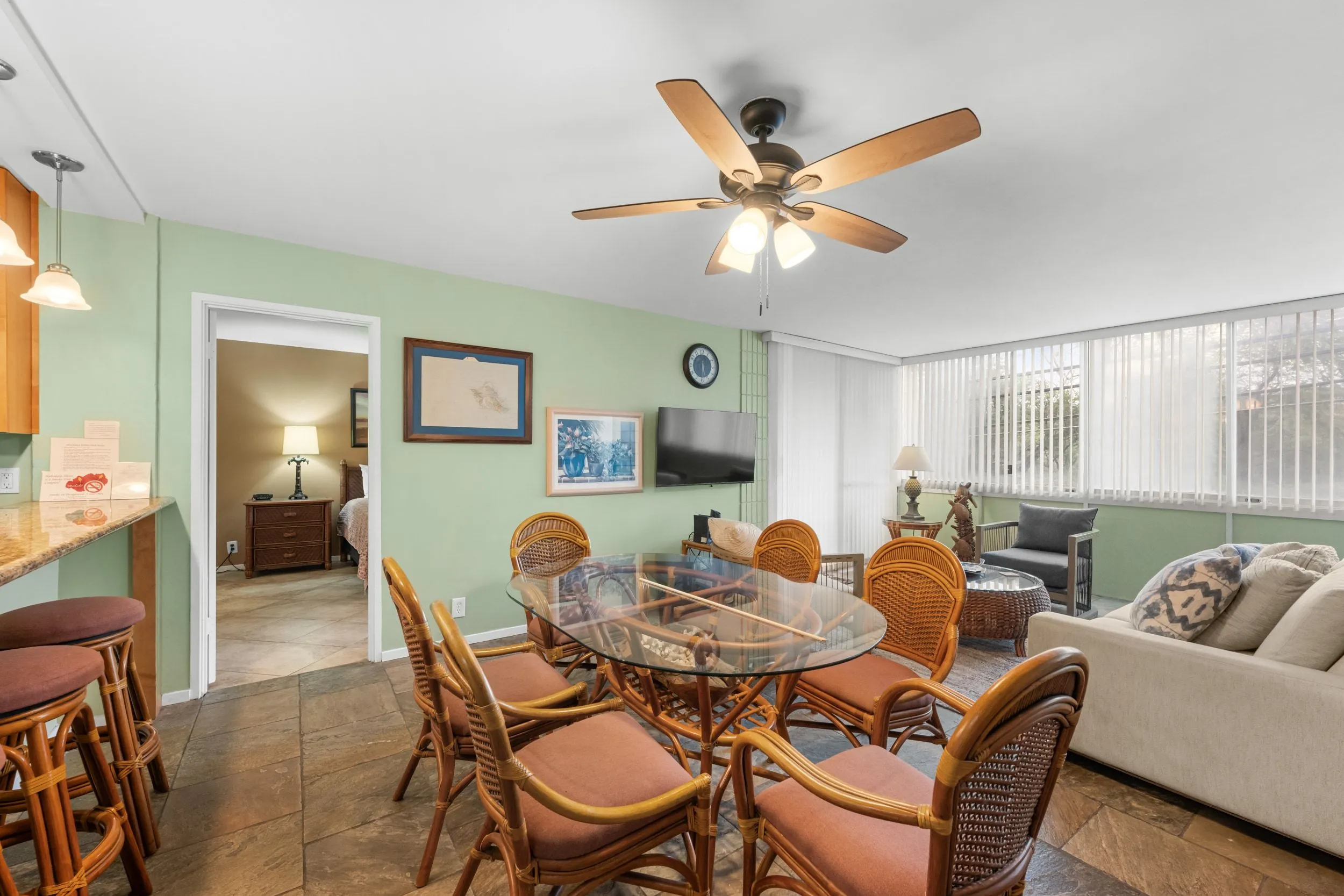 Dining table for six with the living room and lanai beyond