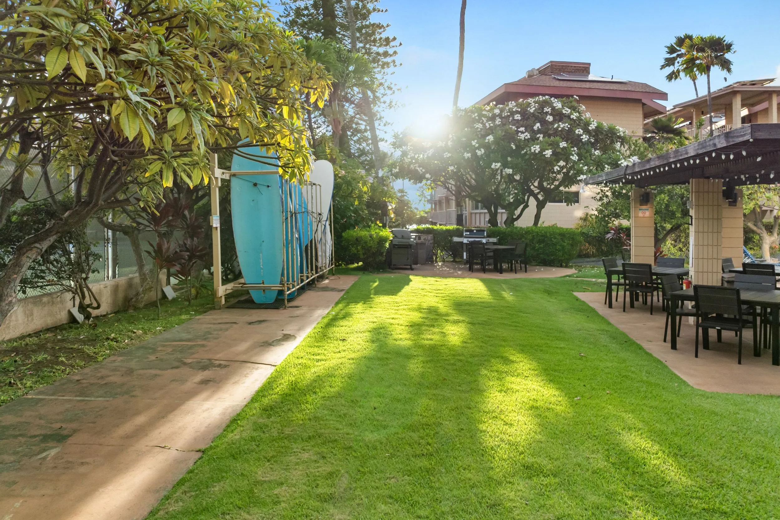 Lawn and a shaded pergola on the resort grounds