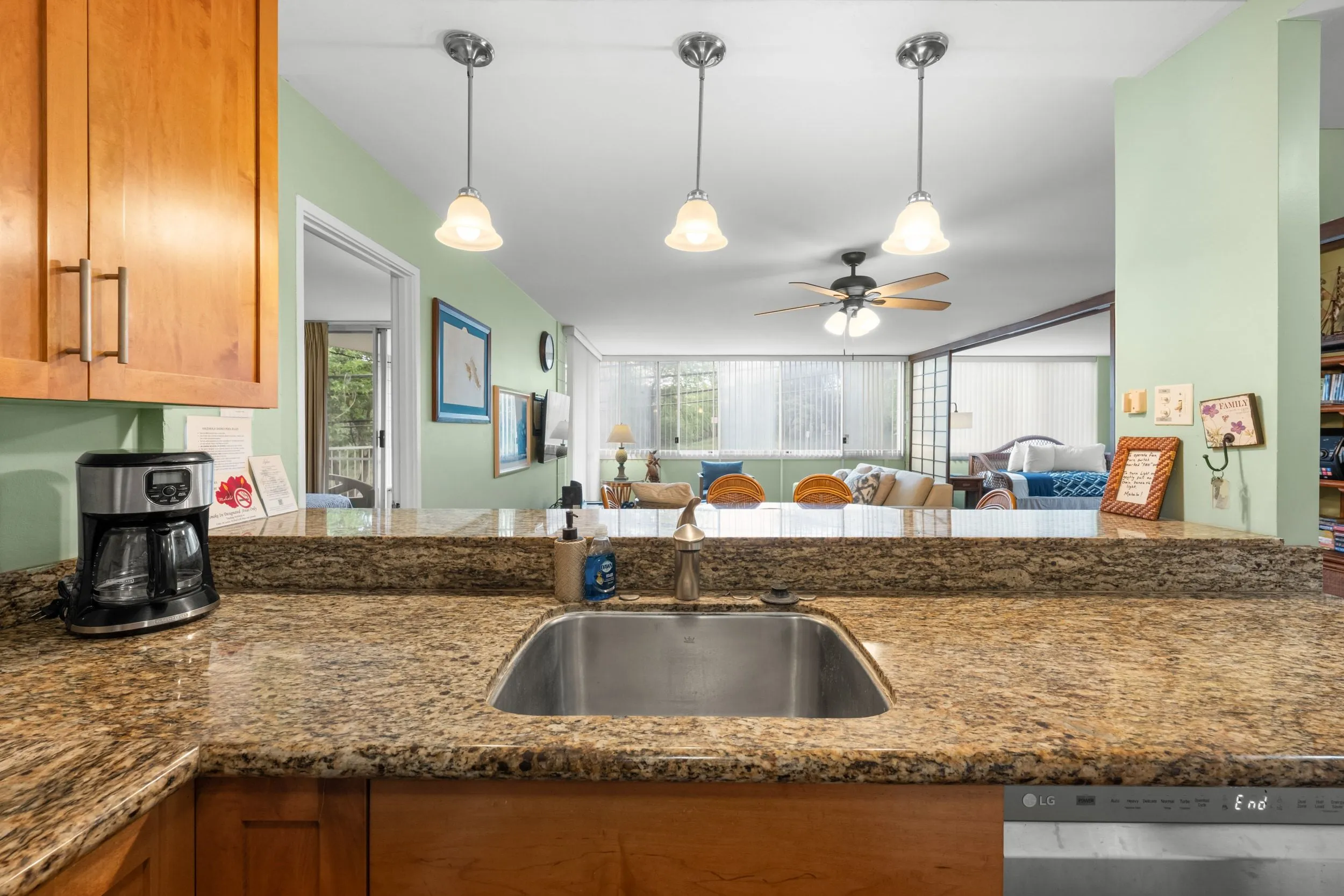 Kitchen sink and breakfast bar under pendant lights