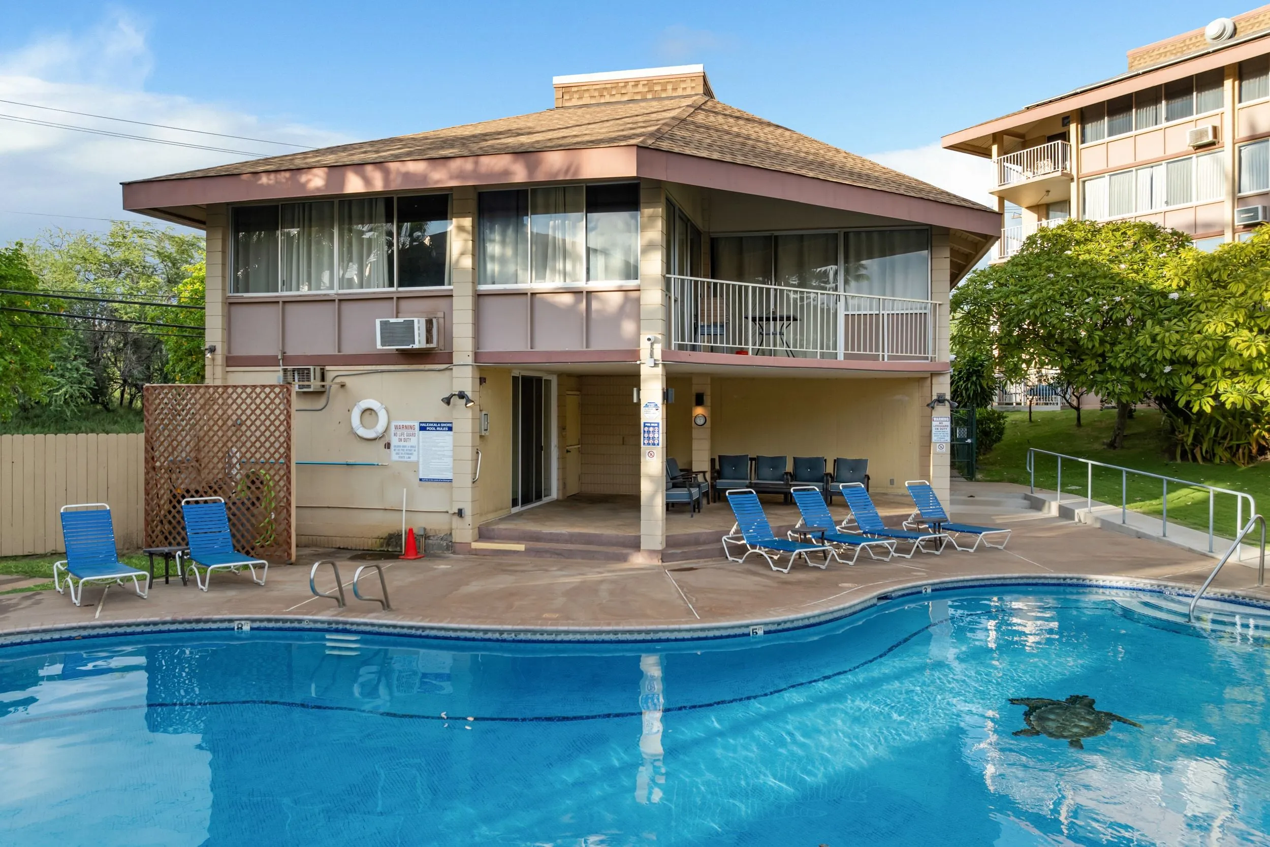 Resort pool with the condo building and its lanais behind