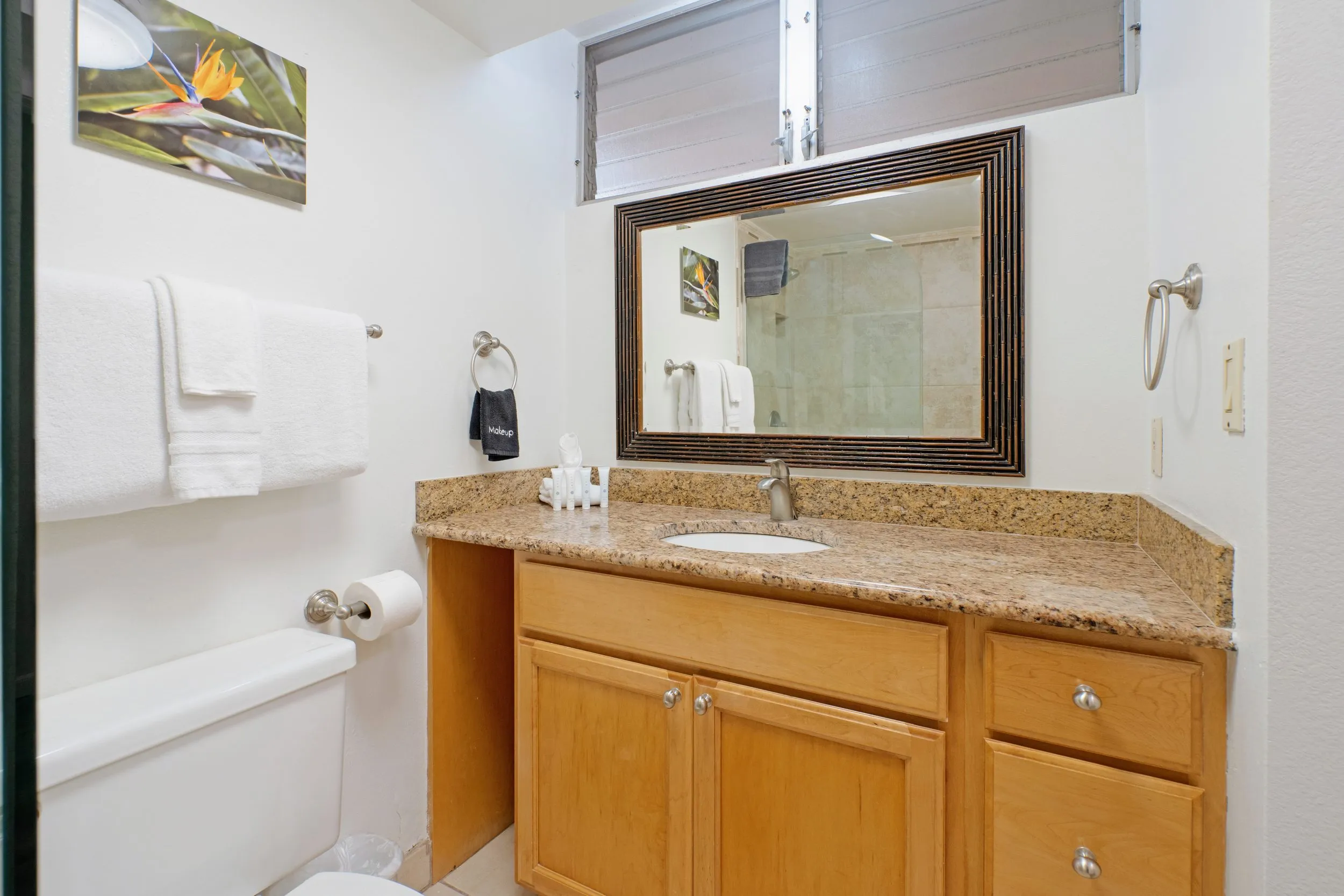 Bathroom vanity with a framed mirror and folded towels