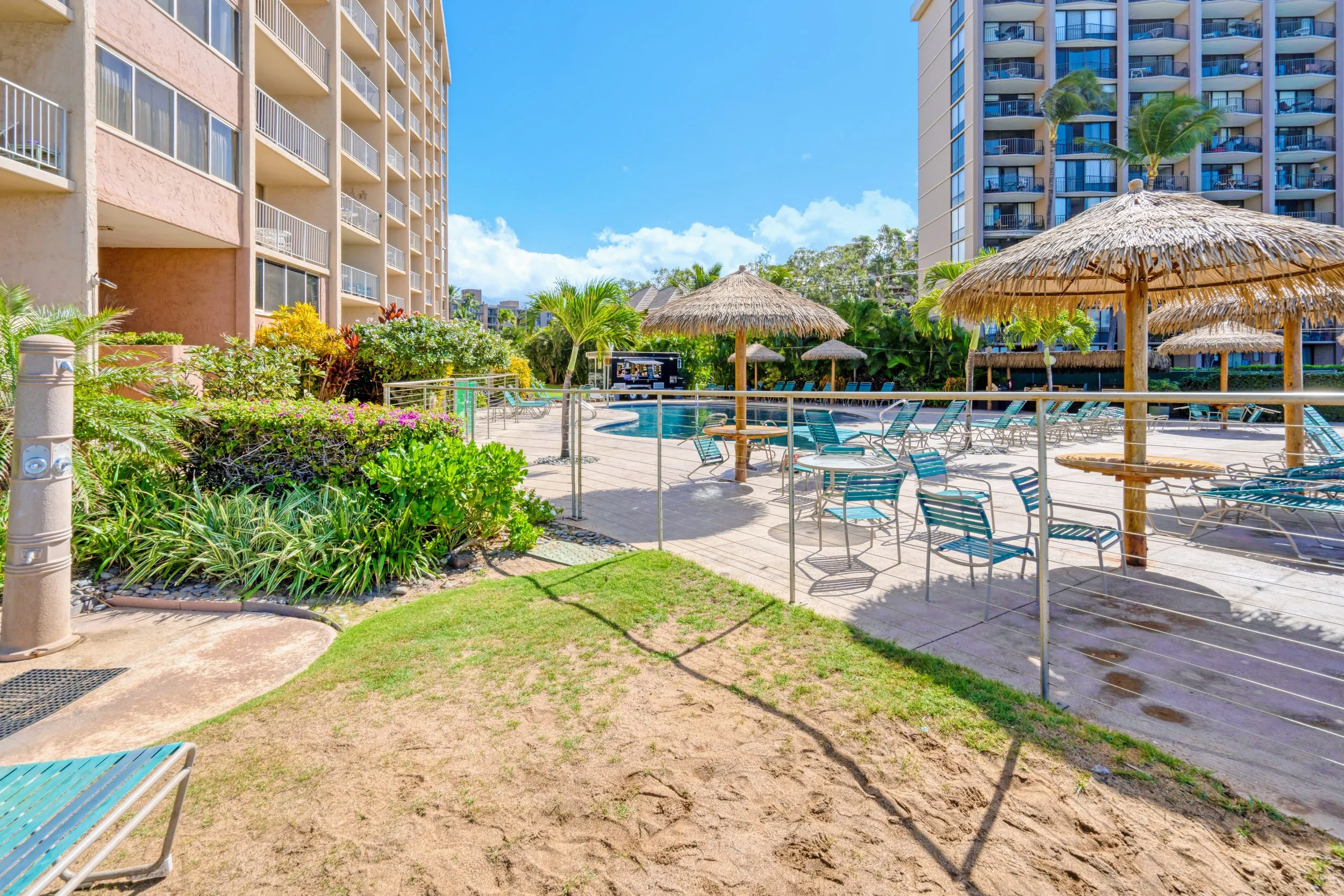 Resort pool and lawn leading down to the beach