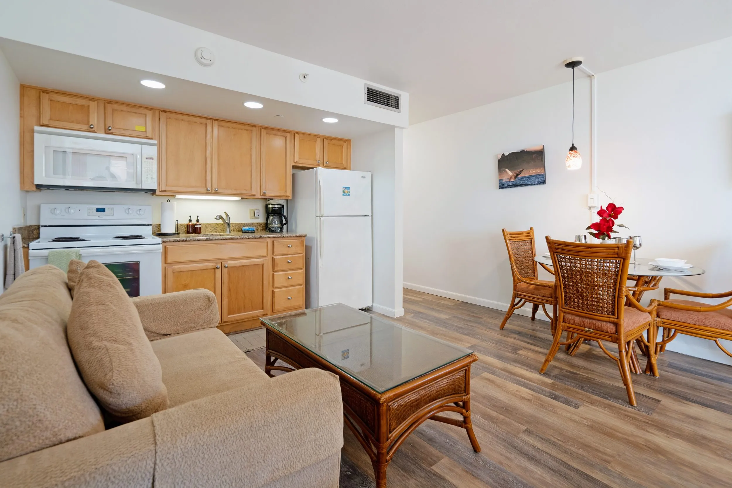 Living area with a sofa, dining table and kitchenette