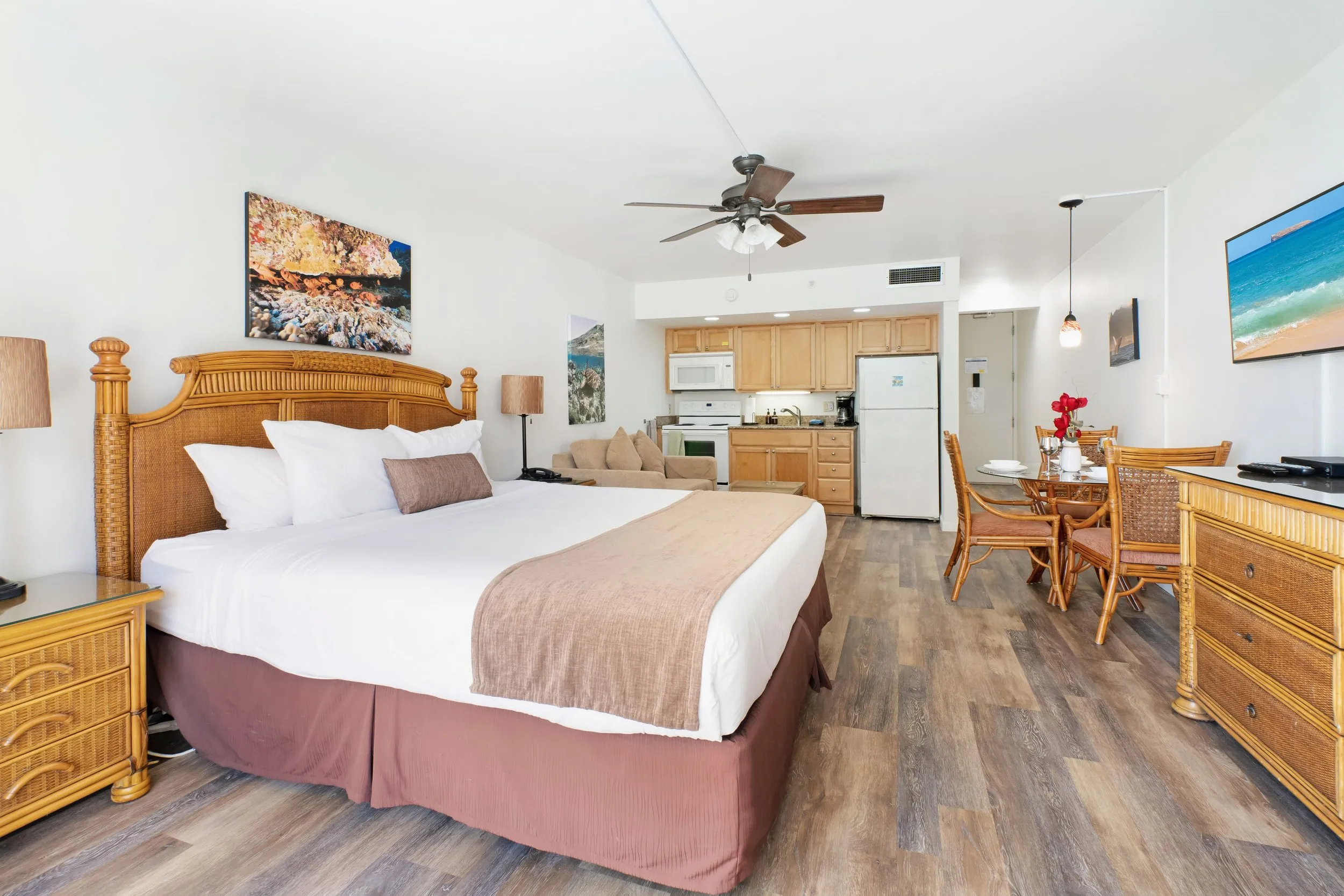 Wide view of the studio: king bed, dining table and kitchen